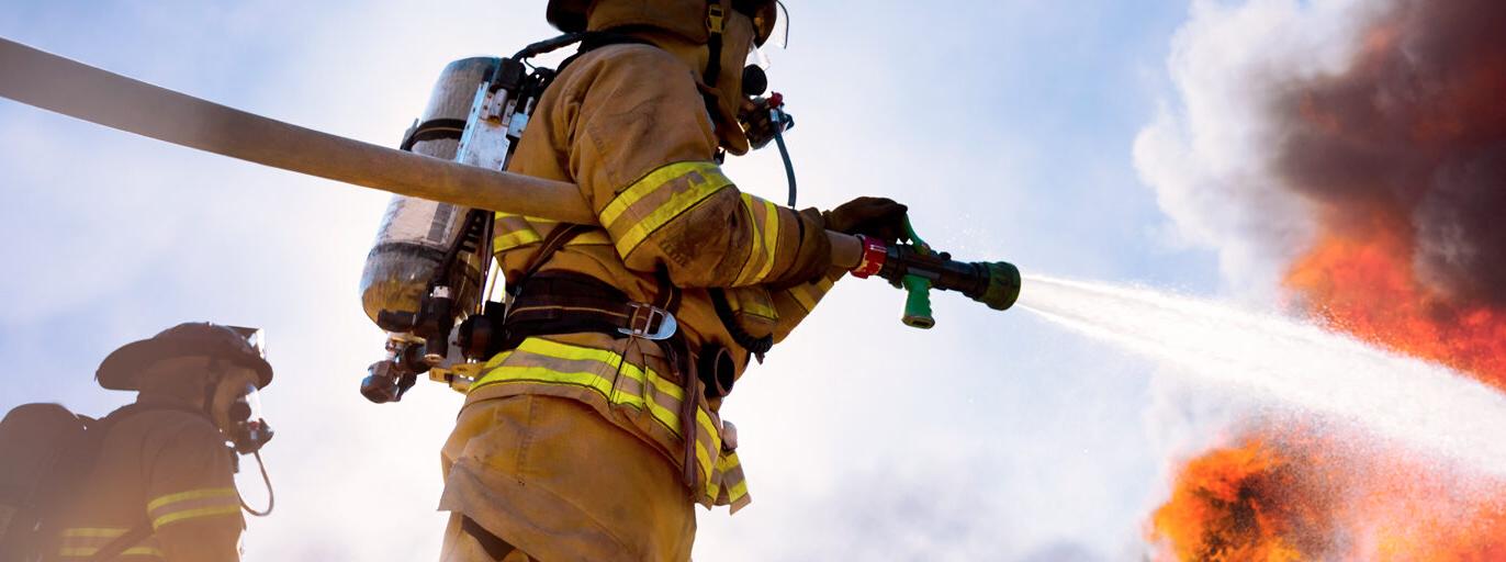 firefighter using a water hose